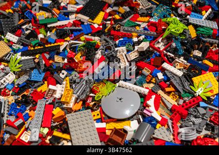Brightly colored lego building bricks spread out, showcasing creativity and playfulness on a table. Stock Photo