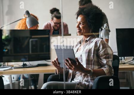 Software, coding and business woman on tablet thinking of data analytics, digital technology. Stock Photo