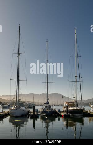 Boats in the still water of the Sausalito, California marina with Mount Tamalpais in the background. Stock Photo