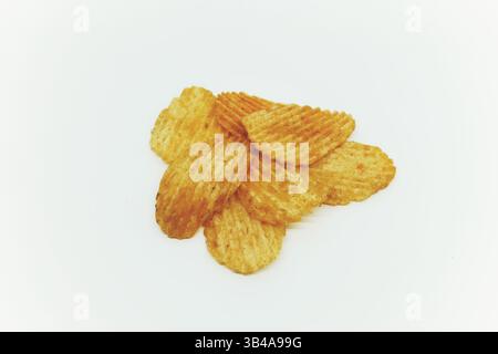 Textured thinly sliced potato chips snack with seasoning sprinkles isolated on white. Stock Photo