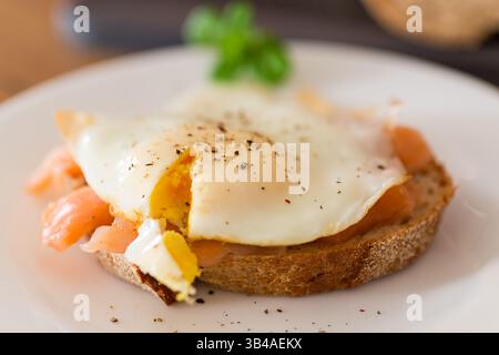 Diet breakfast with cooked egg and lightly salted red fish. Stock Photo