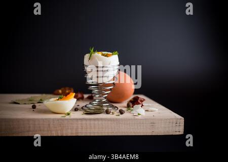 morning soft boiled egg in egg cup isolated on black background. Stock Photo