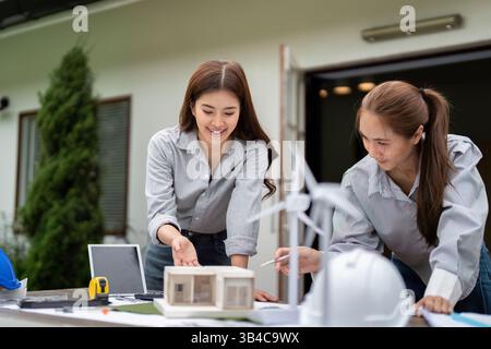 Sustainable Practices in Architecture. Architects reviewing plans for an eco-friendly building project. Stock Photo