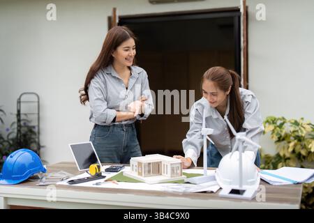 Eco-Friendly Architecture Collaboration. Architects working together on sustainable building plans. Stock Photo