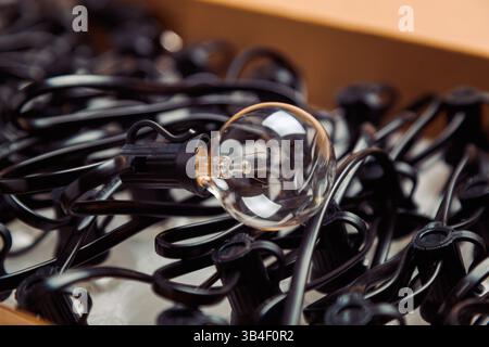 Garland with incandescent bulbs in a cardboard box, retro style Stock Photo