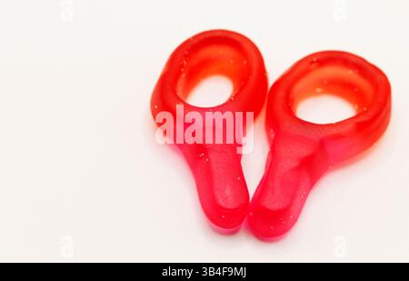 two bright red ring-shaped gummy candies on white background Stock Photo