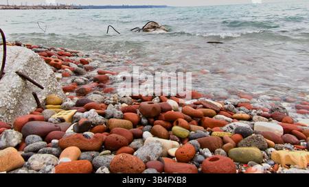 Lake Ontario transformed bricks into rounded pebbles creating this textured field. A mix of history and environment visible in each stone. Stock Photo