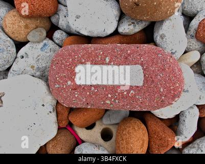 Stones lie quietly in the cold Ontario water washed smooth from past life as part of homes and buildings. Stock Photo