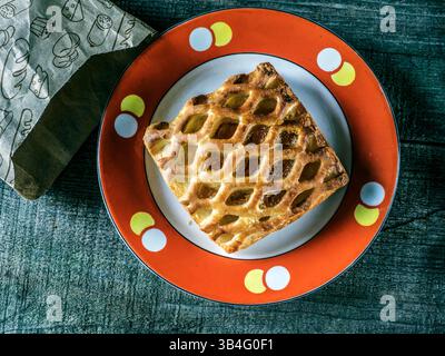 Oct. 11, 2015 - Cake from flaky pastry with apricot jam on the old plate with red border on vintage weathered wooden background (Credit Image: © Igor Goiovniov via ZUMA Wire) Stock Photo