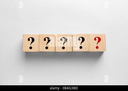 Wooden cubes with question marks on light grey background, top view Stock Photo