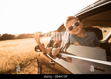 Family road trip smiling mother son enjoying a sunshine vacation. Stock Photo