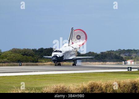 With drag chute unfurled, space shuttle Discovery lands on Runway 33 at ...