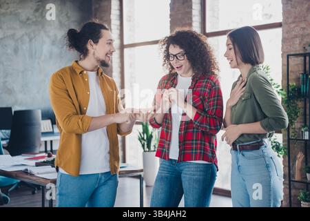 Young Diverse Team Engaged in Discussion While Collaborating in a Modern Office Environment Stock Photo