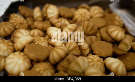 Small kurabye cookies are neatly arranged in a cardboard box, creating a visually appealing display of baked goods Stock Photo