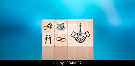 Wooden blocks with symbol of strategic alliance concept on blue background Stock Photo