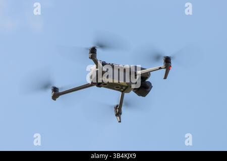 A drone flies in the air taking photos and videos Stock Photo