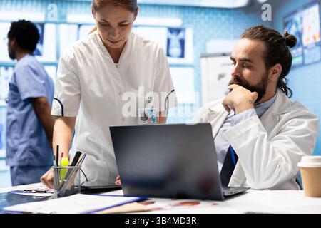 Medical staff collaborates on diagnostic procedures and treatment plans. Radiology specialists work on accurate diagnosis and effective disease prevention, healthcare industry insurance. Stock Photo