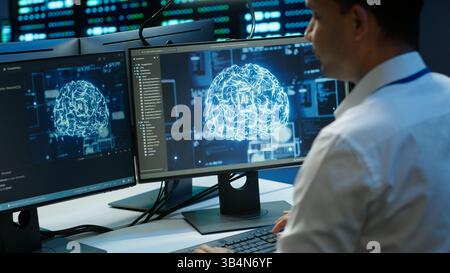 Computer scientist using AI tech on PC to do checkup in server room. IT staff member in data center using artificial intelligence technology to process datasets for training, camera A Stock Photo