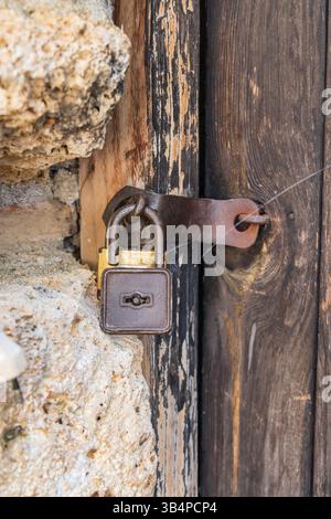 Ohrid, North Macedonia. Rusted padlock on an old wooden door. Stock Photo