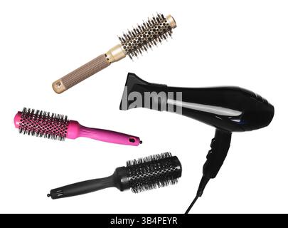 Hair dryer and round brushes in air on white background, collage Stock Photo