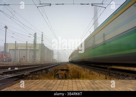 Gyor, Hungary - November 10, 2024: Whispers of Departure: Fog Dancing on the Tracks at Dawn Stock Photo