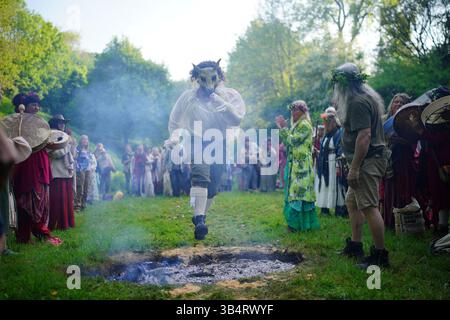 People jump the fire during the Beltane celebrations at Glastonbury