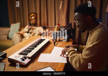 Man Reading Script Of Podcast Stock Photo