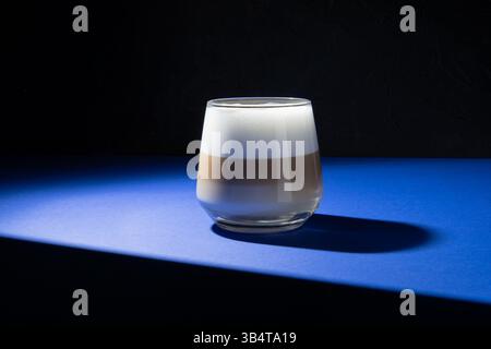 Coffee latte on a dark blue background. Studio lighting used. Stock Photo