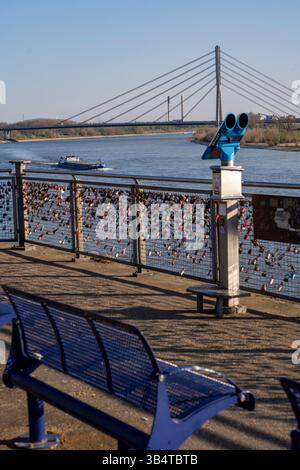 Padlocks, so-called love locks on a fence, viewpoint in Wesel on the Rhine, Rhine bridge, cargo ship, North Rhine-Westphalia, Germany Stock Photo