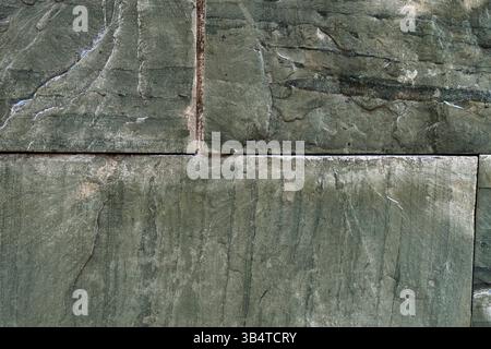 Green marble wall of rough colored blocks. Abstract background. Stock Photo