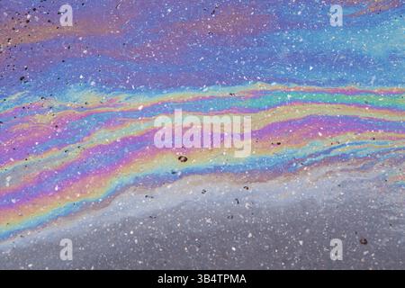 Gasoline spilled on the pavement. Space background picture. Mood. Stock Photo