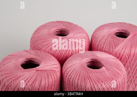 Spools of pink thread on a gray background. Photo for a banner. Stock Photo