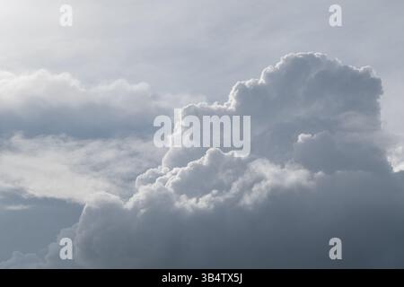 White curly clouds on a gentle blue sky. Stock Photo