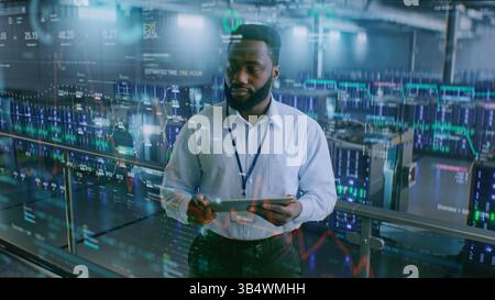 Futuristic Big Data Center with VFX: African American Administrator Using Digital Tablet. Animated Diagrams of Internet Traffic on Servers. Information Technology, Digitalization Concept. Medium Shot. Stock Photo