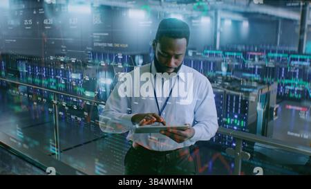 Futuristic Big Data Center with VFX: African American Administrator Using Digital Tablet. Animated Diagrams of Internet Traffic on Servers. Information Technology, Digitalization Concept. Medium Shot. Stock Photo