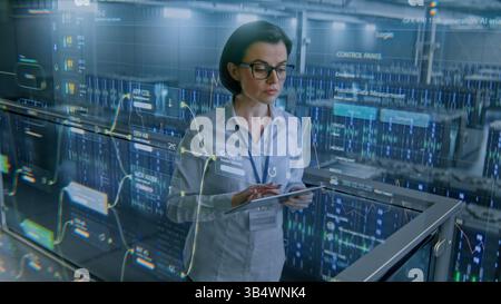 Futuristic Big Data Center with VFX: Female Specialist Using Tablet Computer. Animated Charts of Cloud Computing and Internet Traffic on Servers. Information Technology, Digitalization. Medium Shot. Stock Photo