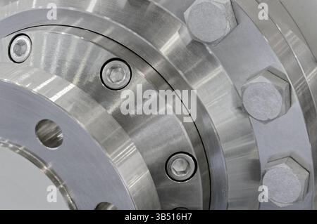 Various parts of high pressure equipment - stainless steel pipes, flanges and plugs, close up shot, abstract industrial background Stock Photo
