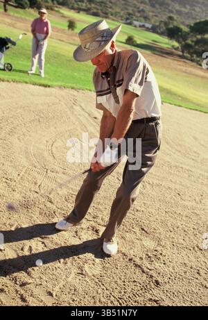 Senior man & woman playing golf. Stock Photo