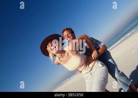 Lifestyle. Happy young couple at the beach. Stock Photo
