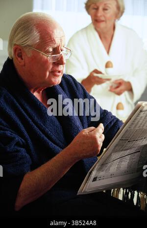 Senior man & woman indoors at home. Stock Photo