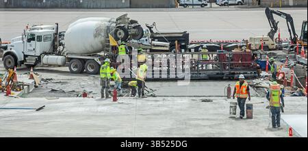 Denver, Colorado - Workers pouring concrete on the tarmac at Denver International Airport. Stock Photo