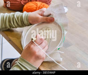 Child punch needle embroidery craft close-up Stock Photo