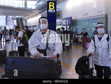 September 26, 2022, HONG KONG, CHINA: A young couple from China Mainland dressed in protective clothing and the face shields walking through Arriving Hall at Hong Kong International Airport. Hong Kong is relaxing mandatory hotel quarantine for international visitors starting today.Sept-26,2022Hong Kong.ZUMA/Liau Chung-ren (Credit Image: © Liau Chung-ren/ZUMA Press Wire) Stock Photo