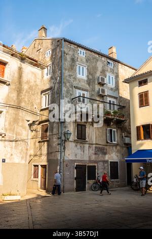 Cres, Croatia-July 25th, 2024: Aged facades of old, stone houses in the town of Cres, named after the island where it is located, famous tourist desti Stock Photo