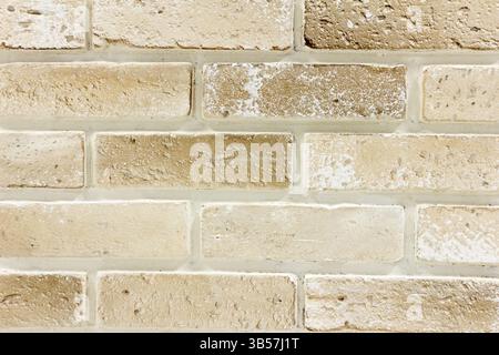 Light brown Ornamental brick wall forms part of interior in house inside Stock Photo