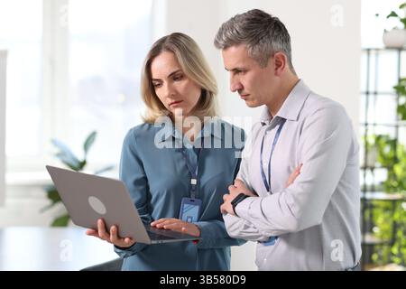 Engineers working together with laptop in office Stock Photo