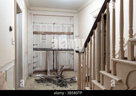 A barricaded front door inside an abandoned house. This house has since been demolished Stock Photo