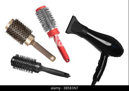Hair dryer and round brushes in air on white background, collage Stock Photo