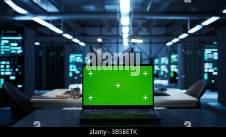 Focus on isolated screen laptop used by engineers in high tech data center to monitor security threats. Close up of chroma key notebook used by workers ensuring compliance with regulations Stock Photo