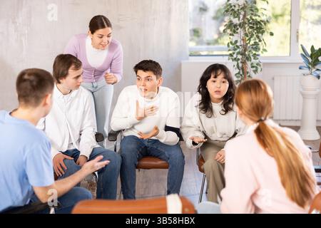 Group of students studying for difficult test in studygroup together Stock Photo